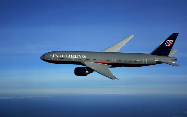 Jetliner flying blue sky ocean free wallpaper - medium preview image