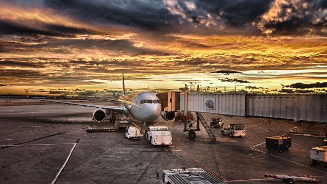 Plane parked tarmac airport sunset free wallpaper - medium preview image