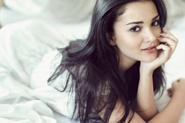 Woman laying bed hand cheek free wallpaper - medium preview image