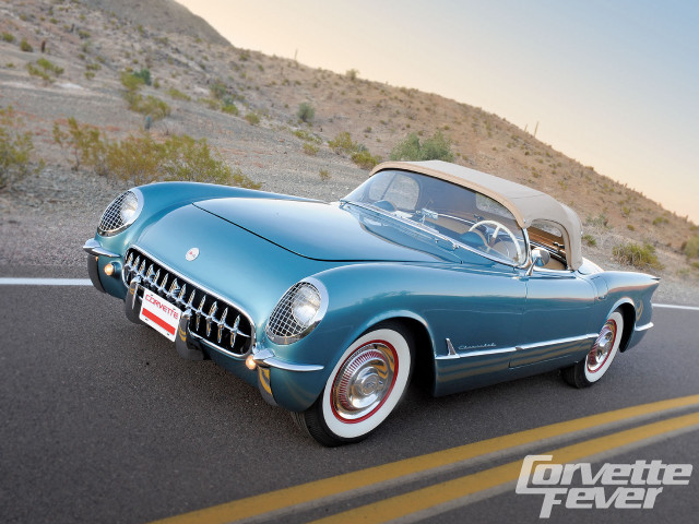 Blue car driving road hillside free wallpaper - medium preview image