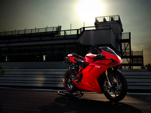 Red motorcycle parked building night free wallpaper - medium preview image