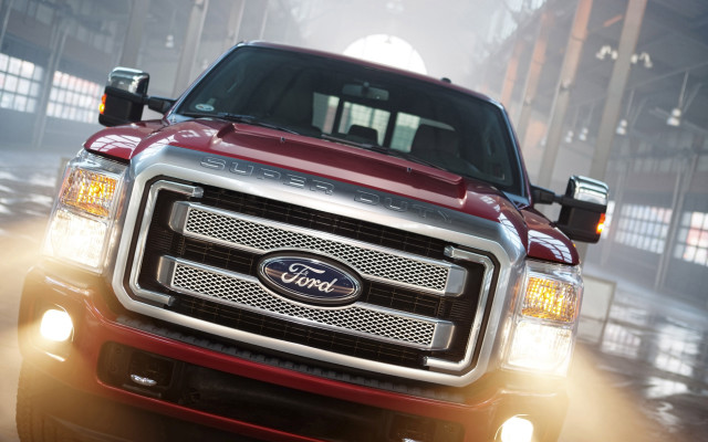 Red truck driving street building free wallpaper - medium preview image
