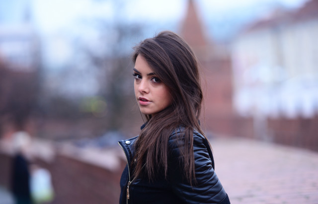 Woman black jacket brick wall free wallpaper - medium preview image