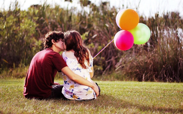Couple grass balloons kissing smiling free wallpaper - medium preview image