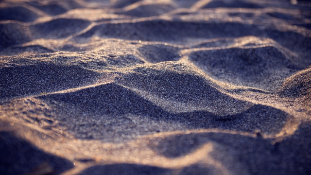 Sandy beach small waves blurry free wallpaper - medium preview image