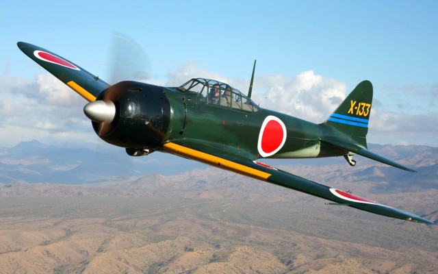 Green airplane flying mountain range free wallpaper - medium preview image
