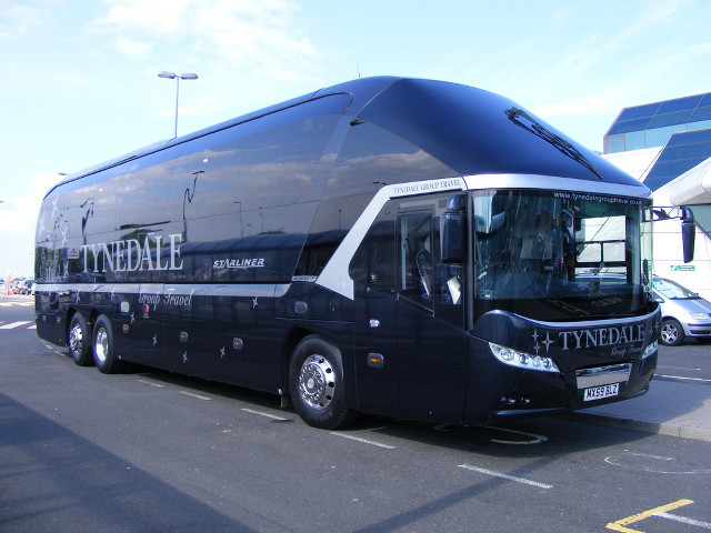 Large black bus parking lot free wallpaper - medium preview image