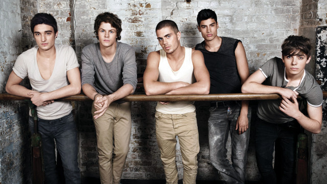 Young men arms crossed brick free wallpaper - medium preview image