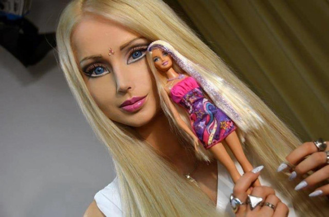 Barbie doll holding doll in free wallpaper - medium preview image