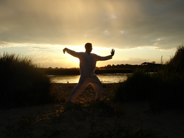 Man beach arms outstretched sunset free wallpaper - medium preview image