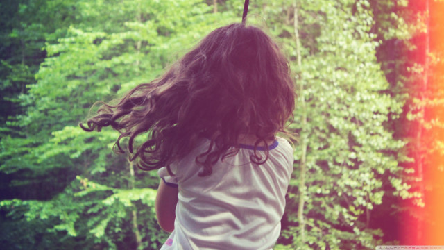 Little girl swinging rope forest free wallpaper - medium preview image