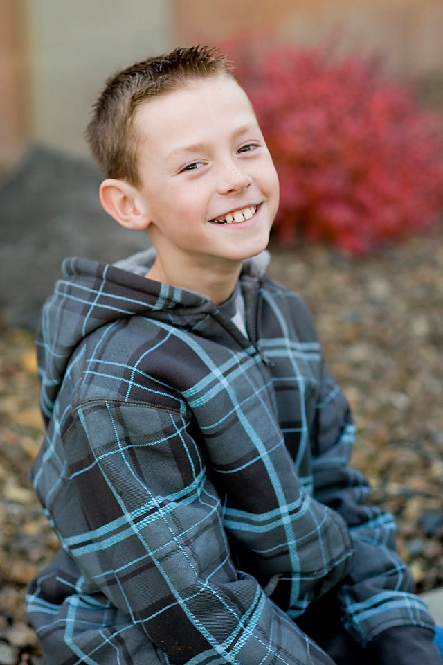 Young boy rock smiling camera free wallpaper - medium preview image