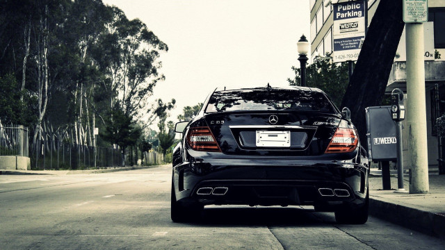 Black car tall building street free wallpaper - medium preview image