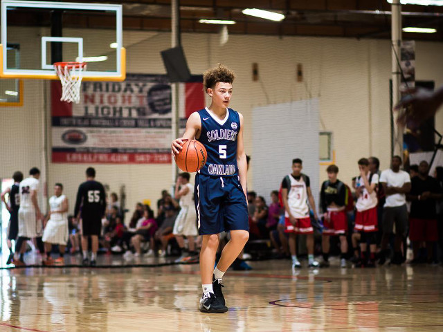 Young man dribbling basketball court free wallpaper - medium preview image