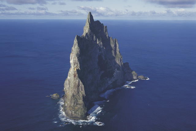 Large rock formation ocean boat free wallpaper - medium preview image