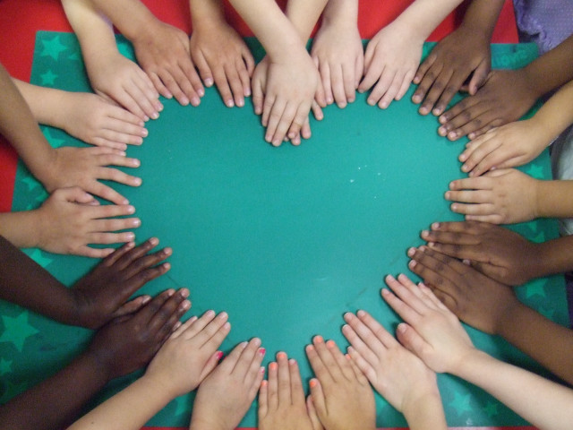 Holding hands circle green surface free wallpaper - medium preview image