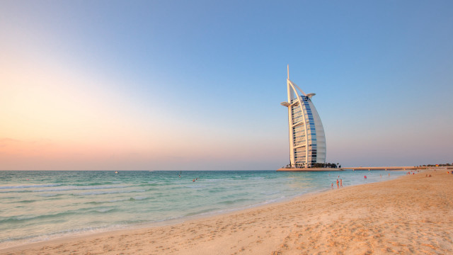 Tall building sandy beach ocean free wallpaper - medium preview image