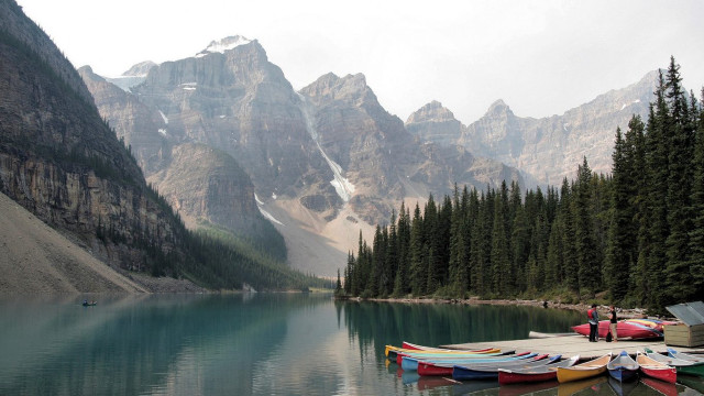 Canoes docked lake mountains snow free wallpaper - medium preview image