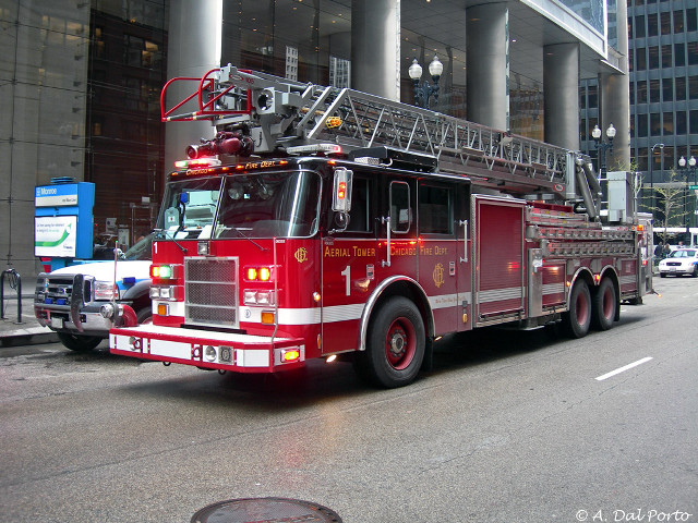 Fire truck parked building hose free wallpaper - medium preview image