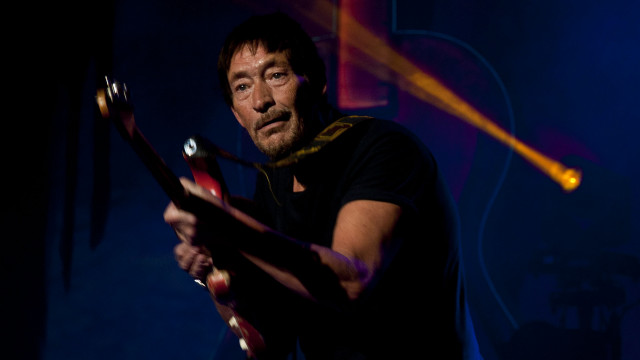 Man holding guitar microphone performance free wallpaper - medium preview image