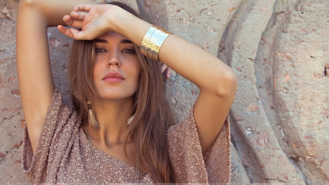 Woman bracelet rock wall holding free wallpaper - medium preview image
