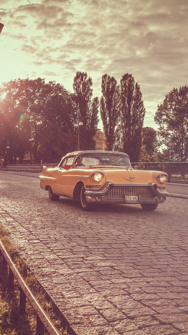 Car parked cobblestone road fence free wallpaper - medium preview image