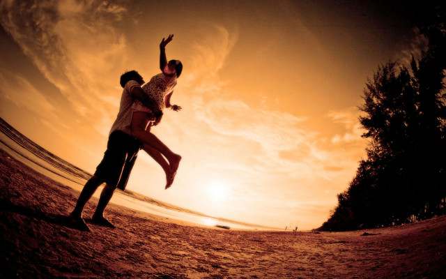 Beach sunset man woman playing free wallpaper - medium preview image