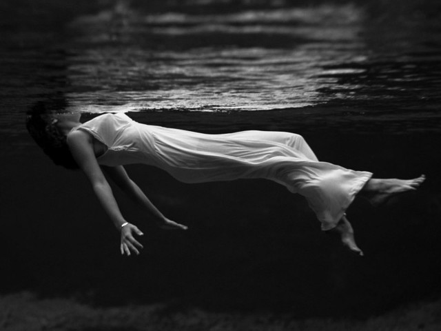 Woman floating water arms outstretched free wallpaper - medium preview image