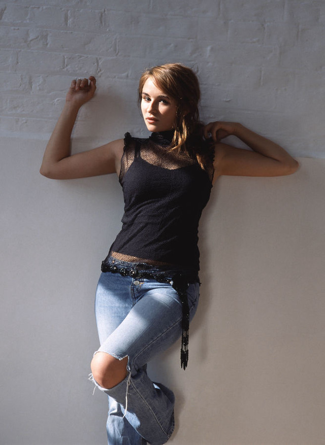 Woman leaning wall arms behind free wallpaper - medium preview image