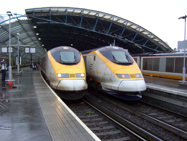 Two trains parked station rain free wallpaper - medium preview image
