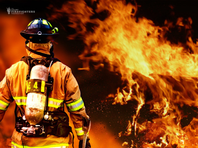 Firefighter standing front fire background #2 free wallpaper - medium preview image