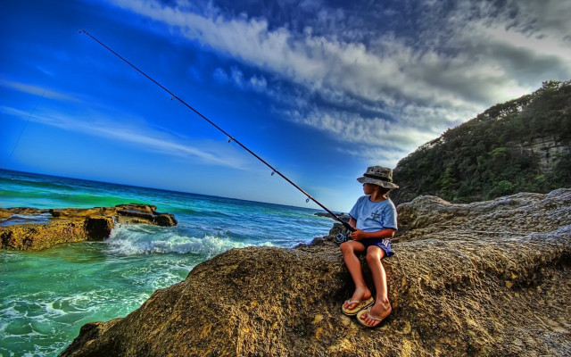 Man sitting rock fishing ocean free wallpaper - medium preview image