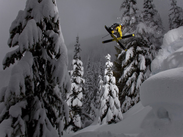 Snowboarder jumping snowy hill woods free wallpaper - medium preview image