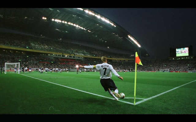 Soccer player kicking night stadium free wallpaper - medium preview image