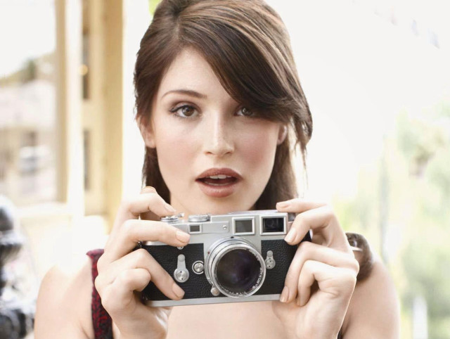 Woman holding camera surprised expression free wallpaper - medium preview image