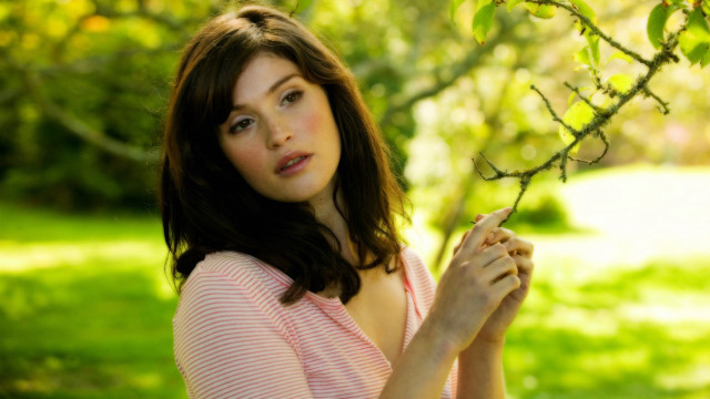 Woman pink shirt holding branch #2 free wallpaper - medium preview image