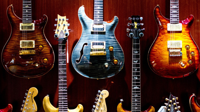Guitars lined up on wall free wallpaper - medium preview image