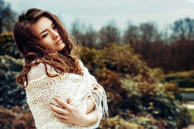 Woman white sweater holding frisbee free wallpaper - medium preview image