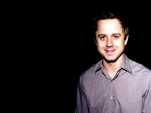 Man shirt smiling camera black free wallpaper - medium preview image