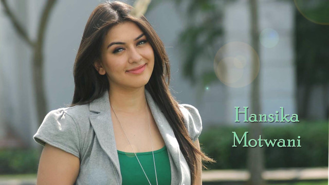 Woman longhair grayjacket smiling greenbackground free wallpaper - medium preview image