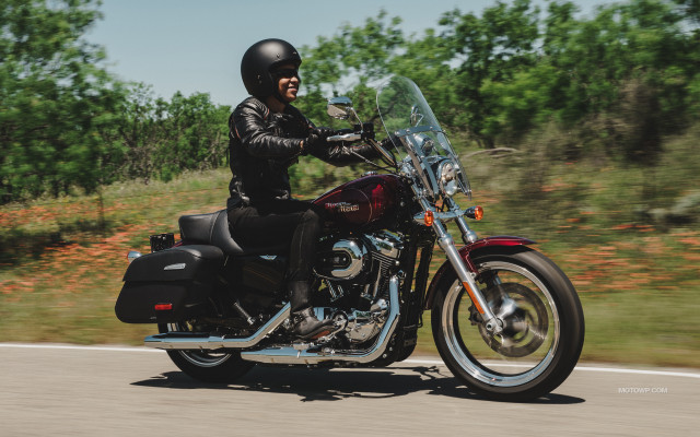 Man riding motorcycle forest sunny free wallpaper - medium preview image