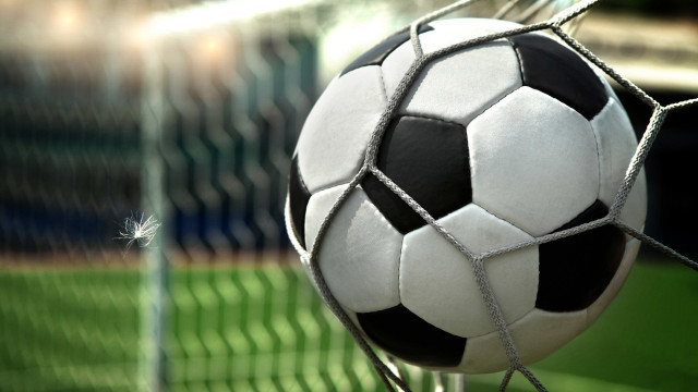 Soccer ball stuck in net free wallpaper - medium preview image