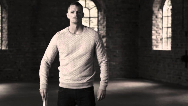 Man white sweater holding frisbee free wallpaper - medium preview image