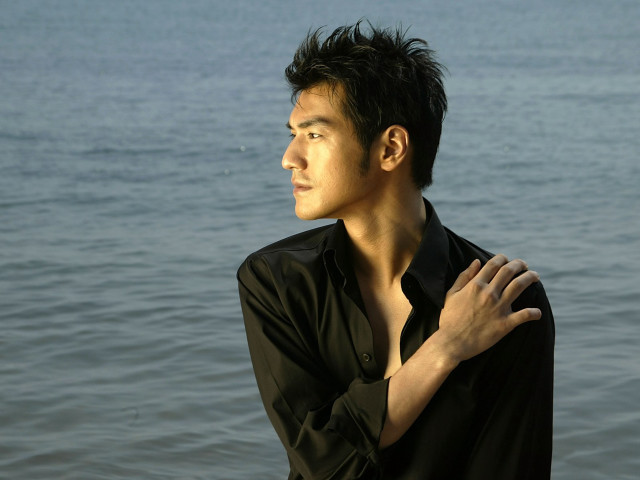 Man standing water hands chest free wallpaper - medium preview image