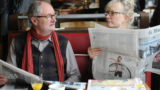 Man woman table newspapers orange free wallpaper - medium preview image
