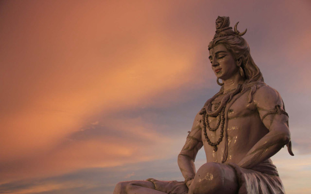 Statue man sitting rock sky free wallpaper - medium preview image