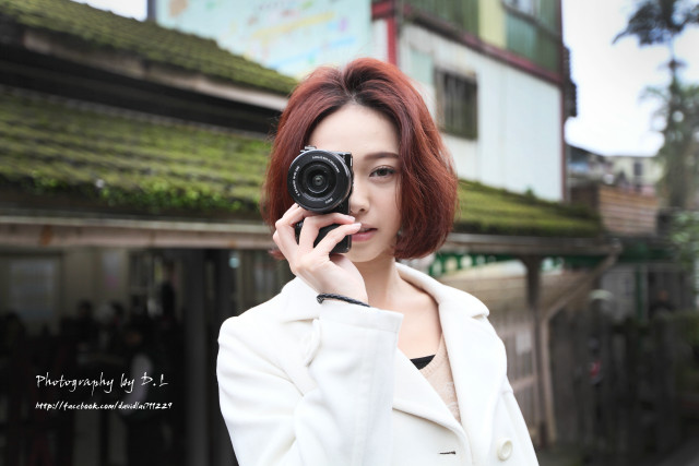 Woman taking picture camera building free wallpaper - medium preview image