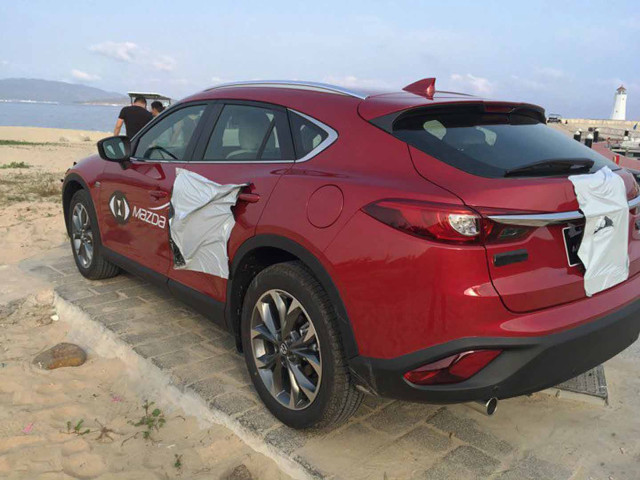 Red car white sheet beach free wallpaper - medium preview image