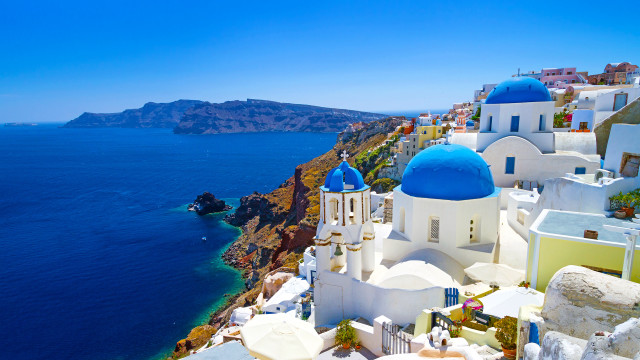 Cliffside blue white building ocean free wallpaper - medium preview image