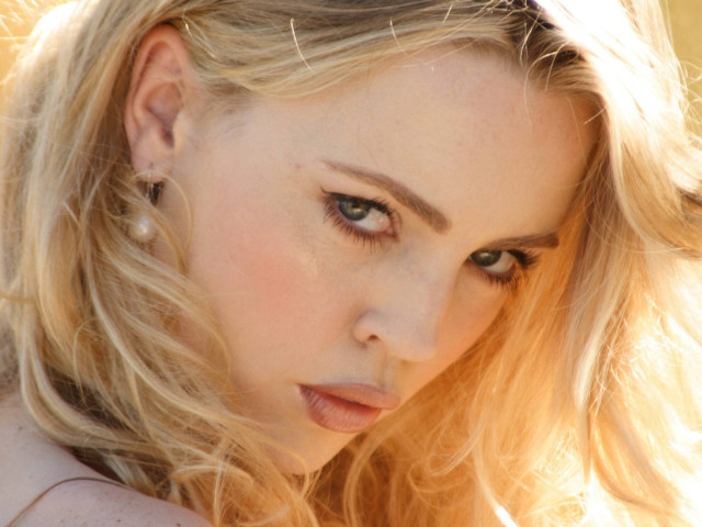 Blonde woman pink shirt wind free wallpaper - medium preview image